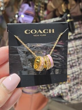 COACH Gold-Tone Necklace with Pink Enamel Ring Pendants